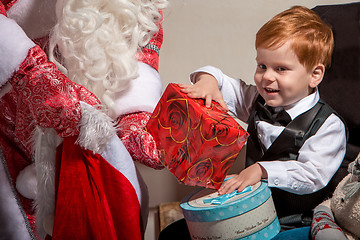 Image showing holidays and people concept - smiling little boy with santa claus 
