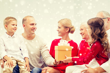 Image showing smiling family with gifts at home