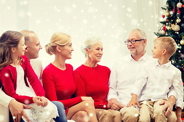 Image showing smiling family sitting and talking at home