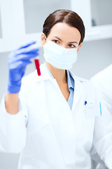 Image showing close up of scientist holding test tube in lab