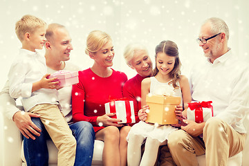 Image showing smiling family with gifts at home
