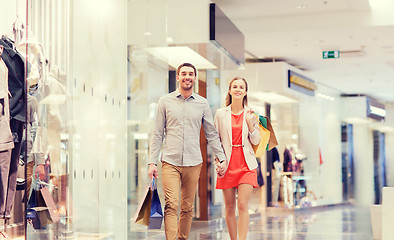 Image showing happy young couple with shopping bags in mall