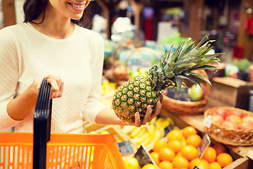 Image showing close up of woman with pineapple in grocery market