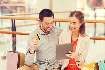 Image showing couple with tablet pc and credit card in mall