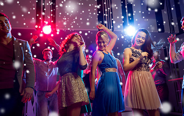 Image showing smiling friends dancing in club