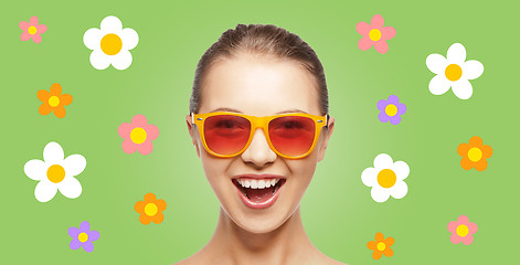 Image showing happy teenage hippy girl in shades with flowers