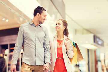 Image showing happy young couple with shopping bags in mall