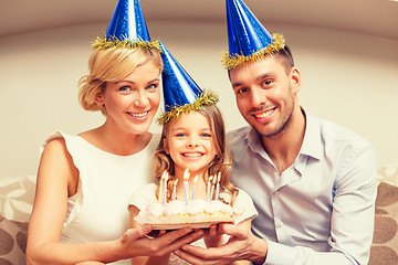 Image showing smiling family in blue hats with cake