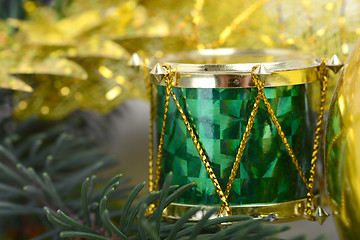 Image showing Christmas background with drums, green eve tree branch, golden new year decoration 