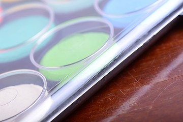 Image showing Watercolor paints set on wooden background