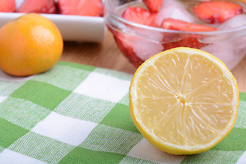 Image showing Close up of a cup of sliced strawberries with lemon