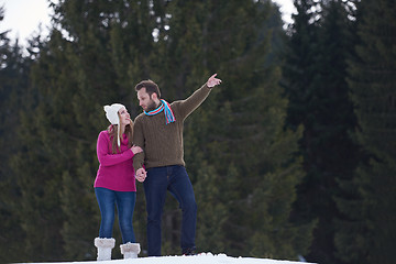 Image showing couple having fun and walking in snow shoes