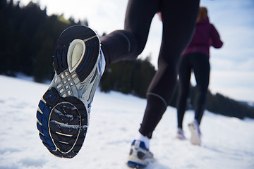 Image showing couple jogging outside on snow