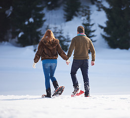 Image showing couple having fun and walking in snow shoes