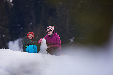 Image showing happy family building snowman