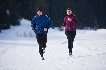 Image showing couple jogging outside on snow