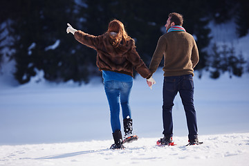 Image showing couple having fun and walking in snow shoes