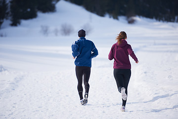 Image showing couple jogging outside on snow