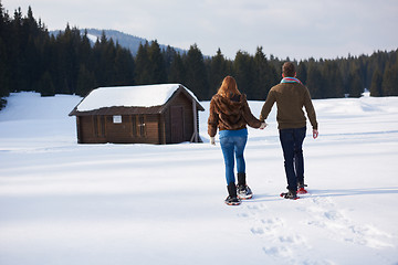 Image showing couple having fun and walking in snow shoes