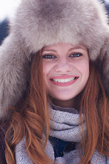 Image showing portrait of beautiful young redhair woman in snow scenery