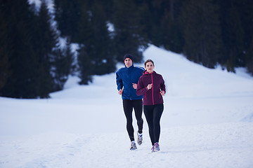 Image showing couple jogging outside on snow