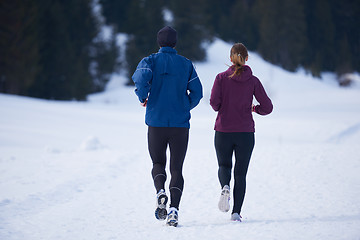 Image showing couple jogging outside on snow