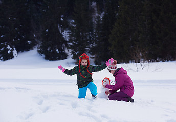 Image showing happy family building snowman