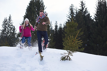 Image showing couple having fun and walking in snow shoes