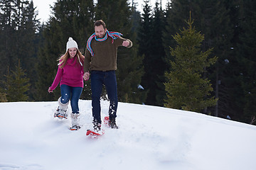 Image showing couple having fun and walking in snow shoes