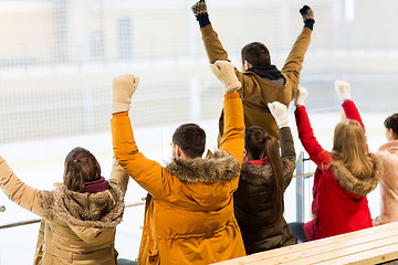 Image showing happy friends supporting team on ice rink arena