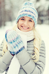 Image showing smiling young woman in winter forest