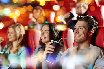 Image showing happy friends watching movie in theater