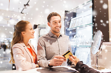 Image showing happy couple choosing engagement ring in mall