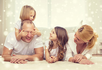 Image showing smiling parents and two little girls at home