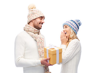 Image showing smiling couple in winter clothes with gift box