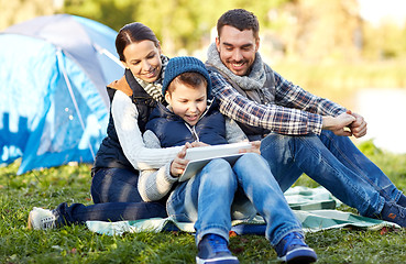 Image showing happy family with tablet pc and tent at camp site