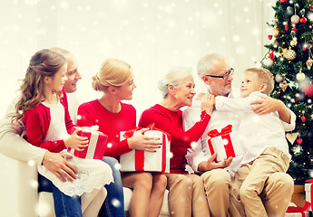 Image showing smiling family with gifts at home