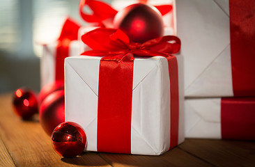 Image showing close up of gift boxes and red christmas balls