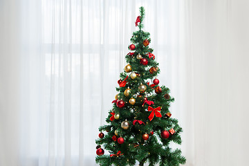 Image showing christmas tree in living room over window curtain