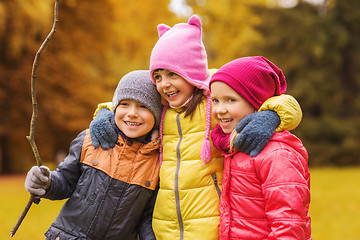 Image showing group of happy children hugging in autumn park