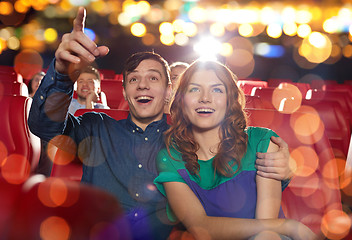 Image showing happy friends watching movie in theater