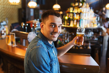 Image showing happy man drinking beer at bar or pub