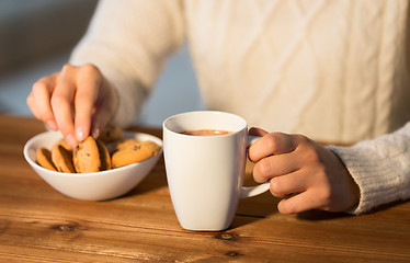 Image showing close up of woman with cookies and hot chocolate