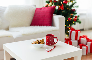 Image showing close up of christmas cookies, sugar cane and cup