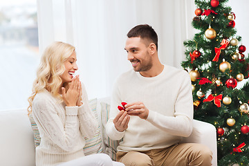 Image showing man giving woman engagement ring for christmas