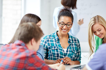 Image showing group of happy high school students with workbook