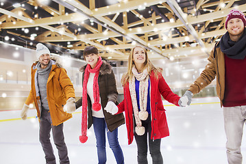 Image showing happy friends on skating rink