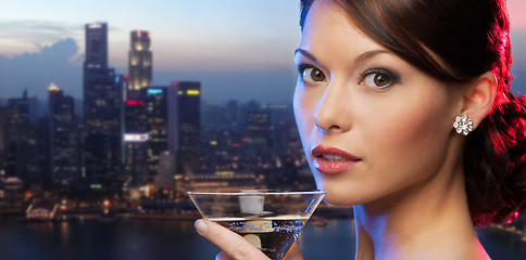 Image showing woman holding cocktail over singapore night city