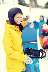 Image showing happy friends in helmets with snowboards