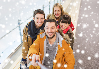 Image showing happy friends taking selfie on skating rink